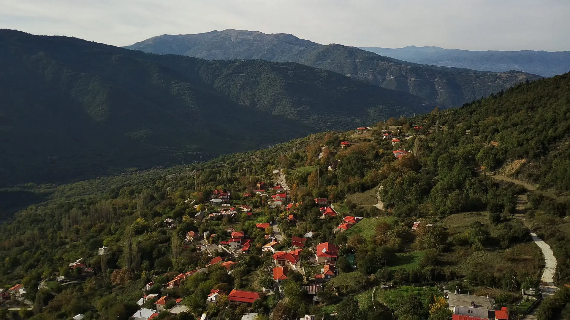 Ο Πύργος Υπάτης στην πλαγιά του βουνού, με κόκκινες στέγες και φθινοπωρινό φως